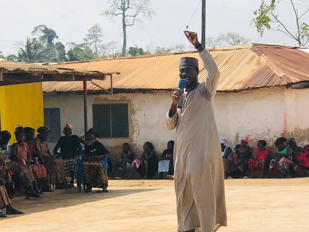 Sheikh addressing a crowd of villagers during a dawa event
