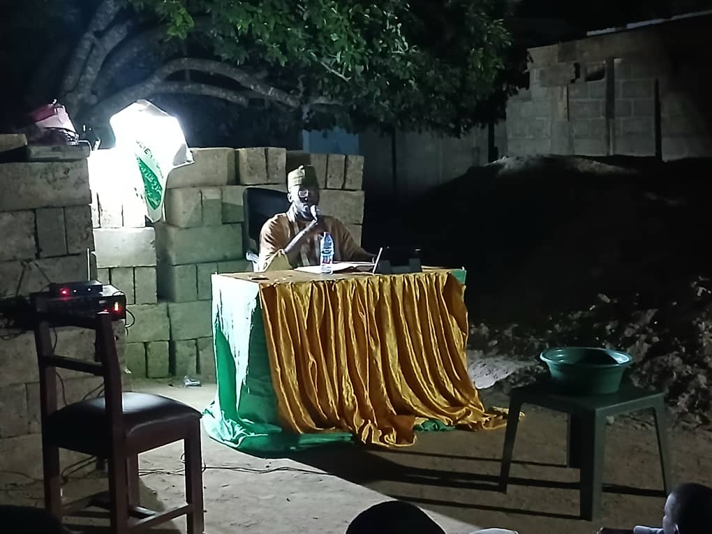 Sheikh Ishaque Abdallah at a night dawa event with a microphone