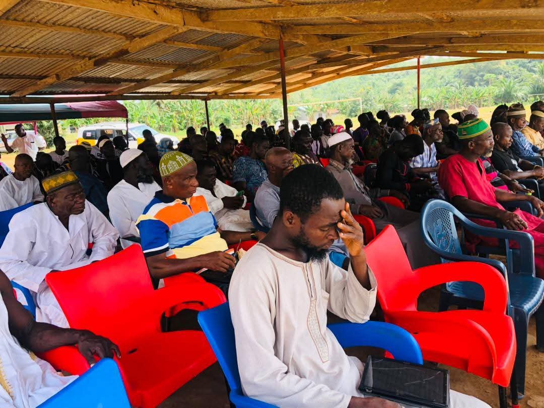 Villagers seated and listening attentively to a preaching session